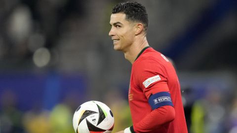 Portugal's Cristiano Ronaldo holds the ball during a quarter final match between Portugal and France at the Euro 2024 soccer tournament in Hamburg, Germany, Friday, July 5, 2024. (AP Photo/Martin Meissner)