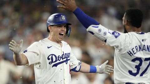 Los Angeles Dodgers' Will Smith, left, is congratulated by Teoscar Hernández after hitting a solo home run during the seventh inning of a baseball game against the Milwaukee Brewers Friday, July 5, 2024, in Los Angeles. (AP Photo/Mark J. Terrill)