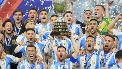 Lionel Messi hoists the trophy after Argentina defeated Colombia in the Copa America final soccer match in Miami Gardens, Fla., Monday, July 15, 2024. (AP Photo/Julio Cortez)