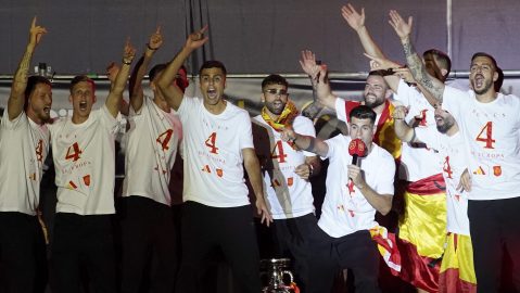 Spain's team captain Alvaro Morata, with the microphone, introduces player Rodri, center, to the fans during celebrations of the Spanish team's European soccer championship title on a stage at Cibeles square in Madrid, Monday, July 15, 2024. Spain defeated England in the final of the Euro 2024 soccer tournament in Berlin on Sunday evening. (AP Photo/Andrea Comas)