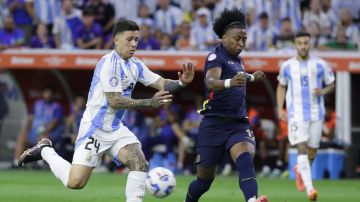 FILE - Ecuador's Angelo Preciado, right, and Argentina's Enzo Fernandez battle for the ball during a Copa America quarterfinal soccer match in Houston, Thursday, July 4, 2024. Chelsea has begun disciplinary action after midfielder Enzo Fernandez was involved in a video where members of Argentina's Copa America-winning squad appeared to sing about French players with African heritage. (AP Photo/Mike Wyke, File)