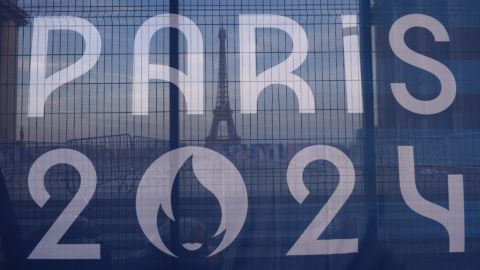 The Eiffel Tower is seen behind a Paris Olympics canvas, from the Trocadero plaza Thursday, July 18, 2024 in Paris. (AP Photo/David Goldman)