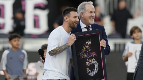 Inter Miami forward Lionel Messi, left, stands with team managing owner Jorge Mas as Messi is awarded for his 45 career trophies before an MLS soccer match against the Chicago Fire, Saturday, July 20, 2024, in Fort Lauderdale, Fla. (AP Photo/Lynne Sladky)