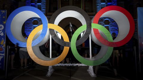Olympic rings are pictured Wednesday, July 24, 2024, in Salt Lake City, while people gather to watch a live stream from Paris as the International Olympic Committee awards Salt Lake City the 2034 Winter Olympics. (AP Photo/Spenser Heaps)