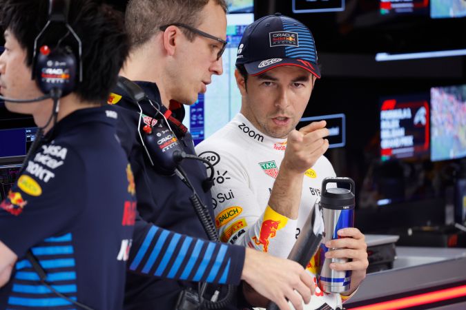 El mexicano Sergio "Checo" Pérez conversando con su equipo luego de la sesión de este viernes de cara al Gran Premio de Bélgica.