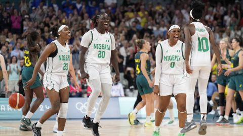 Nigerian players, left to right, Ezinne Kalu, Murjanatu Musa, Amy Okonkwo, of Nigeria, and Promise Amukamara, celebrate after Nigeria defeated Australia in a women's basketball game at the 2024 Summer Olympics, Monday, July 29, 2024, in Villeneuve-d'Ascq, France. (AP Photo/Mark J. Terrill)