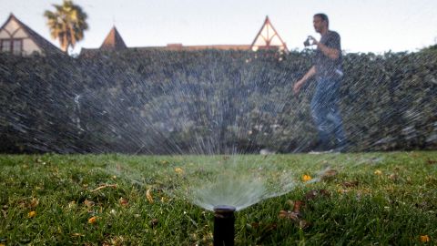 In this Friday, June 5, 2015, photo, Tony Corcoran records sprinklers watering the lawn in front of a house in Beverly Hills, Calif. Corcoran is one of several people who spend their spare time these days canvassing the tony communities of Beverly Hills, West Hollywood and elsewhere, looking for people wasting water during the worst California drought in recent memory. (AP Photo/Jae C. Hong)