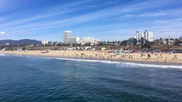 In this photo taken March 18, 2018, the ocean and beach are viewed from the pier in Santa Monica, Calif. An annual "Beach Report Card," released Thursday, June 7, 2018, concludes that low rainfall in California is resulting in less runoff and cleaner water along the coast. Heal The Bay said that a record 37 beaches statewide made its Honor Roll, meaning they are monitored year-round and score perfect A-plus grades each week. (AP Photo/John Antczak)