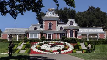 FILE - In this July 2, 2009, file photo, workers standby at the train station at Neverland Ranch in Los Olivos, Calif. Michael Jackson's former home has been renamed Sycamore Valley Ranch. The Los Angeles Times reported March 1, 2017, that it had been relisted for sale for $67 million. (AP Photo/Carolyn Kaster, File)