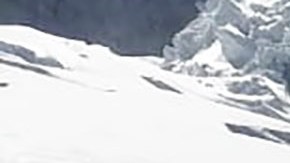 This photo distributed by the Peruvian National Police shows officers surrounding the body of who they identify as U.S. mountain climber William Stampfl, on Huascaran mountain in Huaraz, Peru, July 5, 2024. Peruvian authorities announced on Tuesday, July 9, 2024, that they have found the mummified body of the American man who died 22 years ago, along with two other American climbers, after the three were trapped in an avalanche while trying to climb Peru's highest mountain. (Peruvian National Police via AP)