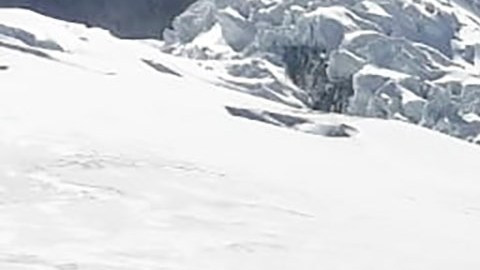 This photo distributed by the Peruvian National Police shows officers surrounding the body of who they identify as U.S. mountain climber William Stampfl, on Huascaran mountain in Huaraz, Peru, July 5, 2024. Peruvian authorities announced on Tuesday, July 9, 2024, that they have found the mummified body of the American man who died 22 years ago, along with two other American climbers, after the three were trapped in an avalanche while trying to climb Peru's highest mountain. (Peruvian National Police via AP)