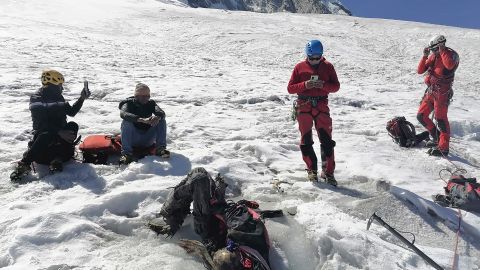 This photo distributed by the Peruvian National Police shows officers surrounding the body of who they identify as U.S. mountain climber William Stampfl, on Huascaran mountain in Huaraz, Peru, July 5, 2024. Peruvian authorities announced on Tuesday, July 9, 2024, that they have found the mummified body of the American man who died 22 years ago, along with two other American climbers, after the three were trapped in an avalanche while trying to climb Peru's highest mountain. (Peruvian National Police via AP)
