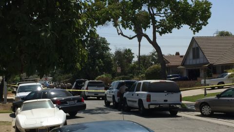 Los Angeles County Sheriff's Department Homicide detectives investigate the fatal stabbing of Elena Moore, a 16-year-old girl inside her two-story home, pictured on the right, Friday, Aug. 12, 2016 in Los Angeles. The Sheriff's department is seeking her 17-year-old ex-boyfriend Rory Murga, in the killing. (AP Photo/Amanda Lee Myers)