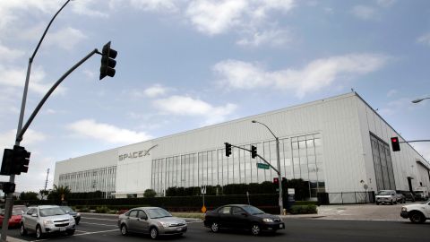 Motorists drive by SpaceX headquarters in Hawthorne, Calif., Friday, May 25, 2012. The privately bankrolled Dragon capsule made a historic arrival at the International Space Station on Friday, triumphantly captured by astronauts wielding a giant robot arm. SpaceX is the first private company to accomplish such a feat: a commercial cargo delivery into the cosmos. (AP Photo/Jae C. Hong)