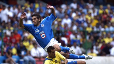 Cruz Azul's Cesar Delgado, top, from Argentina is fouled by America's Raul Salinas at the Aztec stadium in Mexico City Saturday Nov.13, 2004 during their Mexican first division game.( AP Photo/ Claudio Cruz)