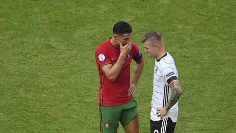 Portugal's Cristiano Ronaldo, left, speaks Germany's Toni Kroos end of the Euro 2020 soccer championship group F match between Portugal and Germany at the football arena stadium in Munich, Saturday, June 19, 2021. (Matthias Hangst/Pool Photo via AP)