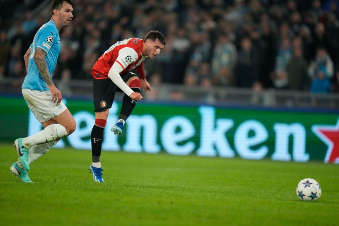 Feyenoord's Santiago Gimenez, right, kicks the ball during the Champions League, Group E, soccer match between Lazio and Feyenoord, at Rome's Olympic stadium, Tuesday, Nov. 7, 2023. (AP Photo/Alessandra Tarantino)