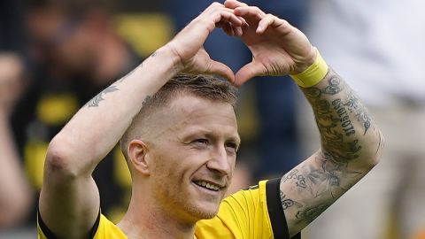 Dortmund's Marco Reus celebrates after scoring his side's 4th goal during the German Bundesliga soccer match between Borussia Dortmund and FC Augsburg in Dortmund, Germany, Saturday, May 4, 2024. The BVB icon announced the leave the club after this season. (AP Photo/Martin Meissner)