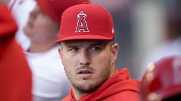 Los Angeles Angels center fielder Mike Trout sits in the dugout during the first inning of the team's baseball game against the Oakland Athletics, Tuesday, June 25, 2024, in Anaheim, Calif. (AP Photo/Ryan Sun)