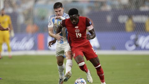 Argentina's Julian Alvarez, left, and Canada's Alphonso Davies vie for the ball during a Copa America semifinal soccer match in East Rutherford, N.J., Tuesday, July 9, 2024. (AP Photo/Adam Hunger)