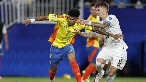 Colombia's Luis Diaz, left, and Uruguay's Guillermo Varela battle for the ball during a Copa America semifinal soccer match in Charlotte, N.C., Wednesday, July 10, 2024. (AP Photo/Nell Redmond)