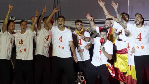 Spain's team captain Alvaro Morata, with the microphone, introduces player Rodri, center, to the fans during celebrations of the Spanish team's European soccer championship title on a stage at Cibeles square in Madrid, Monday, July 15, 2024. Spain defeated England in the final of the Euro 2024 soccer tournament in Berlin on Sunday evening. (AP Photo/Andrea Comas)