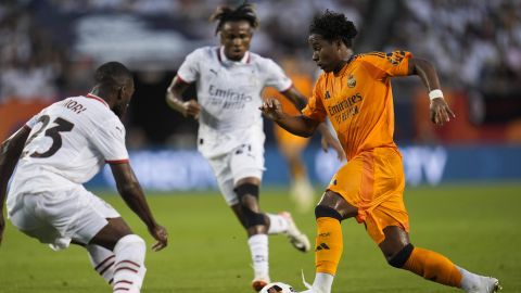 Real Madrid forward Endryck Moreira, right, dribbles the ball by Milan defender Fikayo Tomori during the first half of a friendly soccer match Wednesday, July 31, 2024, in Chicago. (AP Photo/Erin Hooley)