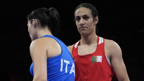 Algeria's Imane Khelif, right, walks beside Italy's Angela Carini after their women's 66kg preliminary boxing match at the 2024 Summer Olympics, Thursday, Aug. 1, 2024, in Paris, France. (AP Photo/John Locher)