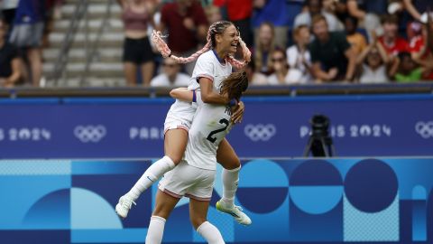 Trinity Rodman of the United States, top, celebrates after scoring the opening goal during the quarterfinal women's soccer match between the United States and the Japan at the Parc des Princes at the 2024 Summer Olympics, Saturday, Aug. 3, 2024, in Paris, France. (AP Photo/Aurelien Morissard)