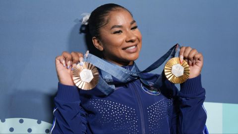 Jordan Chiles, of the United States, holds up her medals after the women's artistic gymnastics individual apparatus finals Bercy Arena at the 2024 Summer Olympics, Monday, Aug. 5, 2024, in Paris, France. (AP Photo/Charlie Riedel)