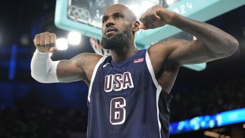 United States' LeBron James flexes after scoring during a men's basketball game against Brazil at the 2024 Summer Olympics, Tuesday, Aug. 6, 2024, in Paris, France. (AP Photo/Michael Conroy)