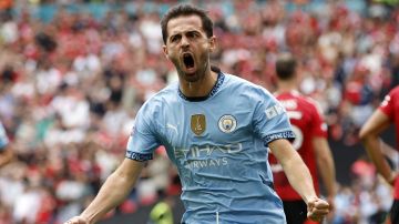 Manchester City midfielder Bernardo Silva celebrates scoring his side's first goal during the FA Community Shield soccer match between Manchester City and Manchester United at Wembley Stadium in London, Saturday, Aug. 10, 2024. (AP Photo/David Cliff)