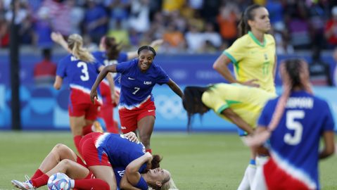 Lindsey Horan of the United States, bottom center, celebrates with her teammates after winning the women's soccer gold medal match between Brazil and the United States at the Parc des Princes during the 2024 Summer Olympics, Saturday, Aug. 10, 2024, in Paris, France. (AP Photo/Aurelien Morissard)