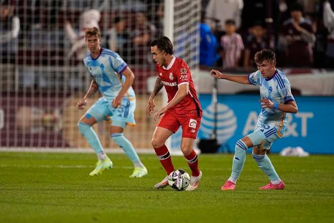 Toluca midfielder Jesús Angulo (10) collects the ball as Colorado Rapids defenders Andreas Maxsø (5) and Sam Vines (3) cover in the first half of a Leagues Cup soccer match Tuesday, Aug. 13, 2024, in Commerce City, Colo. (AP Photo/David Zalubowski)