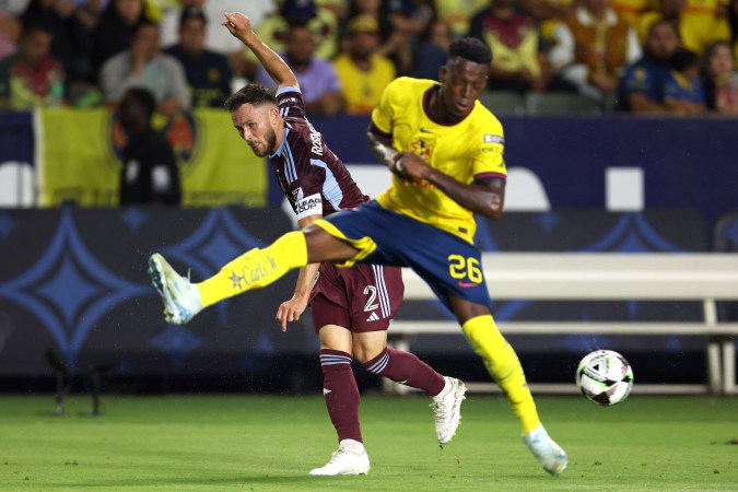 Colorado Rapids defender Keegan Rosenberry (2) kicks the ball past Club America defender Cristian Borja (26) during the first half of a Leagues Cup quarterfinal soccer match Saturday, Aug. 17, 2024, in Carson, Calif. (AP Photo/Raul Romero Jr.)