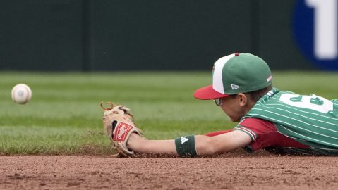 Mexico second baseman Gerardo Cisneros is unable to make a diving stop on a base hit by Cuba's Alejandro Vazquez during the fourth inning of a baseball game at the Little League World Series tournament in South Williamsport, Pa., Tuesday, Aug. 20, 2024. (AP Photo/Tom E. Puskar)