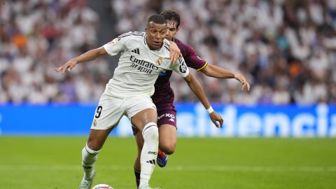 Real Madrid's Kylian Mbappe, left, and Valladolid's Luis Perez challenge for the ball during the Spanish La Liga soccer match between Real Madrid and Valladolid at the Santiago Bernabeu stadium in Madrid, Spain, Sunday, Aug. 25, 2024. (AP Photo/Manu Fernandez)