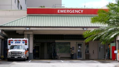 FILE — In this Aug. 24, 2021, file photo an ambulance sits outside the emergency room at The Queen's Medical Center in Honolulu. Health care workers in Hawaii say a lack of government action is worsening an already crippling surge of coronavirus cases in the islands, and without effective policy changes the state's limited hospitals could face a grim crisis. (AP Photo/Caleb Jones, File)