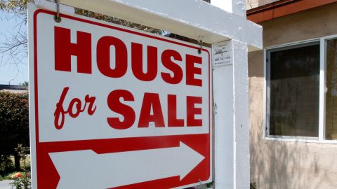 In this June 13, 2011 photo a house is posted "for sale," in Los Angeles. Fewer people purchased previously occupied homes in May, bringing sales down to their lowest level of the year. (AP Photo/Reed Saxon)