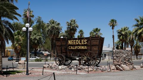 In this June 27, 2019, photo, a sign adorns an historic wagon along the old Route 66 in Needles, Calif. The small desert town bordering Arizona and near the Nevada state line recently labeled itself a "2nd Amendment Sanctuary City." (AP Photo/John Locher)