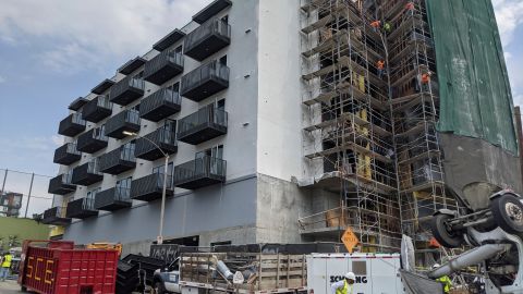 In this June 18, 2021, photo, construction workers finish the exterior of an apartment building downtown Los Angeles. California Gov. Gavin Newsom on Thursday, Sept. 16, 2021, approved two measures to slice through local zoning ordinances as the most populous state struggles with soaring home prices, an affordable housing shortage and stubborn homelessness. Newsom also signed a bill extending a 2019 law designed to make it easier to build more housing throughout the state. (AP Photo/Damian Dovarganes)