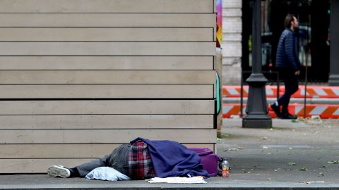 A person sleeps in Pioneer Square in Seattle, Friday, June 28, 2024. The Supreme Court cleared the way for cities to enforce bans on homeless people sleeping outside in public places on Friday, overturning a ruling from a California-based appeals court that found such laws amount to cruel and unusual punishment when shelter space is lacking. (AP Photo/Manuel Valdes)