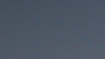 A crowd watches Walid Kasim, 23, a Turkish cyclist living in Lebanon, as he performs a stunt on his bicycle on the Mediterranean Sea waterfront promenade in Beirut, Lebanon, Sunday, April 10, 2016. (AP Photo/Bilal Hussein)