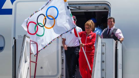 Los Angeles Mayor Karen Bass holds the official Olympic flag returning to Los Angeles at Los Angeles International Airport on Monday, Aug. 12, 2024. (AP Photo/Damian Dovarganes)