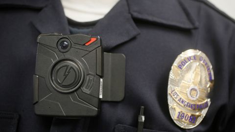 FILE - In this Jan. 15, 2014 file photo a Los Angeles Police officer wears an on-body camera during a demonstration in Los Angeles. An agreement with Boston's largest police union to have 100 officers wear body cameras was praised as a step toward greater accountability. But with the Sept. 1, 2016, rollout date for the pilot program approaching, not a single officer had volunteered to wear one. (AP Photo/Damian Dovarganes, File)