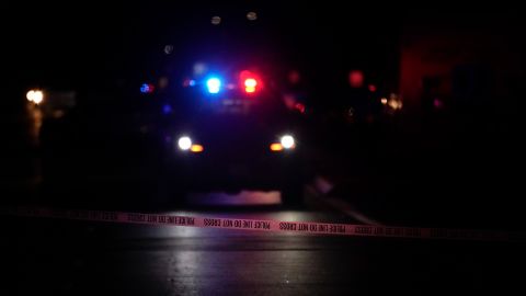 A police tape blocks the street near an office building where a shooting occurred in Orange, Calif., Wednesday, March 31, 2021. The shooting killed several people, including a child, and injured another person before police shot and wounded the suspect, police said. (AP Photo/Jae C. Hong)