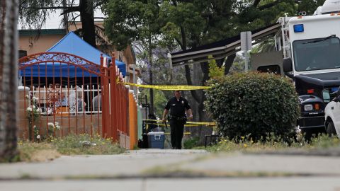 Los Angeles Police investigate a home on 81st Street in Los Angeles on Wednesday, July 7, 2010. A law enforcement official says police made an arrest in the so-called "Grim Sleeper" serial killings in which a man is believed to have killed 11 people since 1985. (AP Photo/Chris Carlson)