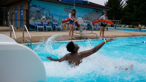 Lifeguards Hailey Landrun, 17, and Rachel Mees, 21, watch over swimmers at the Douglass Park pool in Indianapolis, Friday, June 17, 2022. Indianapolis typically fills 17 pools each year, but with a national lifeguard shortage exacerbated by the COVID-19 pandemic, just five are open this summer. The American Lifeguard Association estimates one-third of pools in the United States are impacted by the shortage. (AP Photo/Michael Conroy)