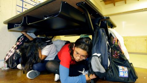 FILE - In this Oct. 15, 2009 file photo, children participate in the "Great California ShakeOut" earthquake drill at the Para Los Ninos Elementary School in Los Angeles. Millions in the United States and several countries are set to participate in an earthquake preparedness drill, dubbed the Great ShakeOut," Thursday, Oct. 18, 2012. (AP Photo/Damian Dovarganes, File)