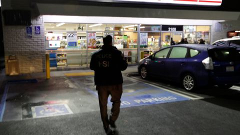 In this Jan. 10, 2018 photo U.S. Immigration and Customs Enforcement agents serve a employment audit notice at a 7-Eleven convenience store in Los Angeles. Agents targeted about 100 stores nationwide Wednesday to open employment audits and interview workers. (AP Photo/Chris Carlson)